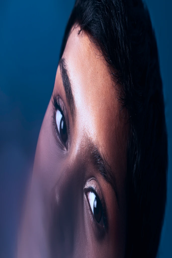 Close-up portrait against a deep blue background